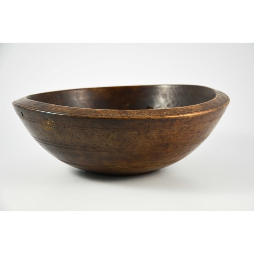 532 - A 19th century or earlier turned treen bowl, fruitwood with concentric banding, 35cm diameter