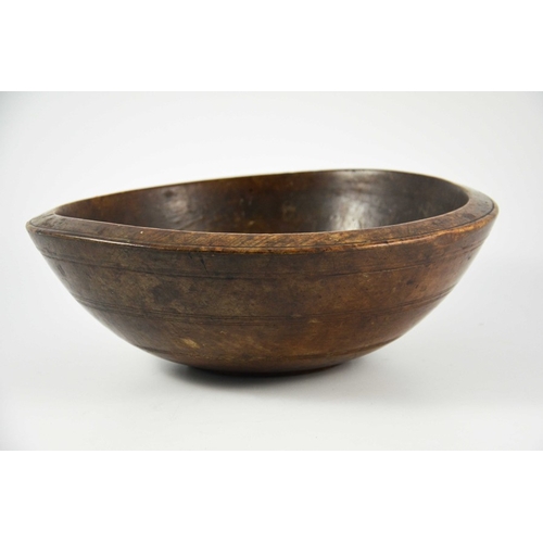 532 - A 19th century or earlier turned treen bowl, fruitwood with concentric banding, 35cm diameter