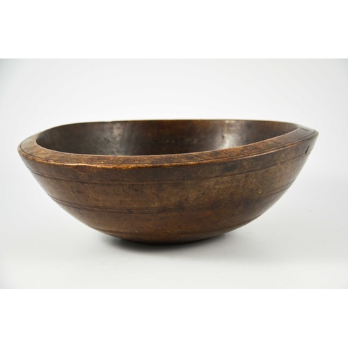 532 - A 19th century or earlier turned treen bowl, fruitwood with concentric banding, 35cm diameter