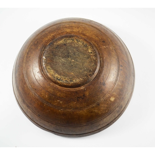 532 - A 19th century or earlier turned treen bowl, fruitwood with concentric banding, 35cm diameter