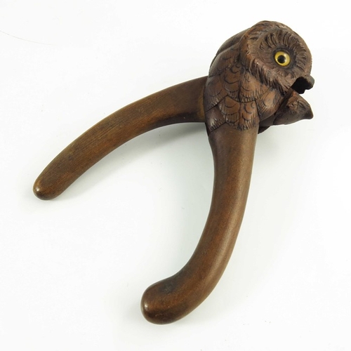 535 - A Hand Carved Wooden Nutcracker in the form of an owl with glass eyes, late 19th/early 20th century,... 