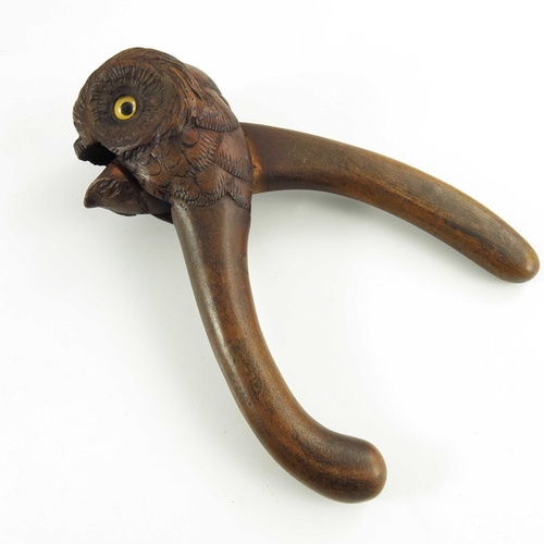 535 - A Hand Carved Wooden Nutcracker in the form of an owl with glass eyes, late 19th/early 20th century,... 