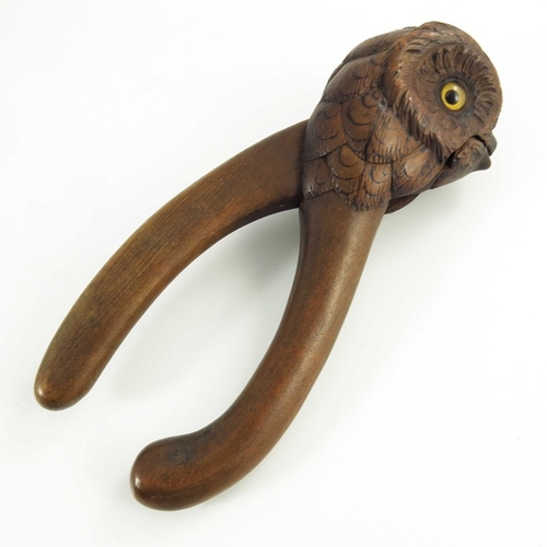 535 - A Hand Carved Wooden Nutcracker in the form of an owl with glass eyes, late 19th/early 20th century,... 