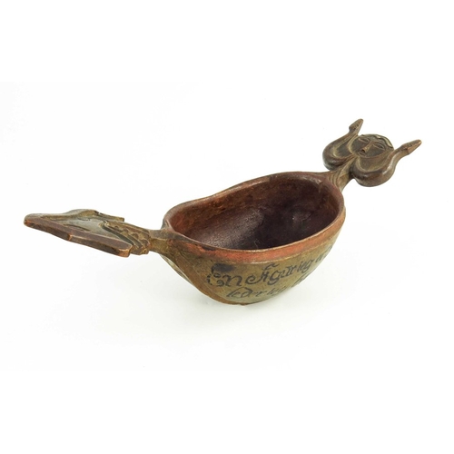 537 - A Scandinavian carved wooden  kasa or drinking bowl, modeled with grotesque heads for handles, hand-... 