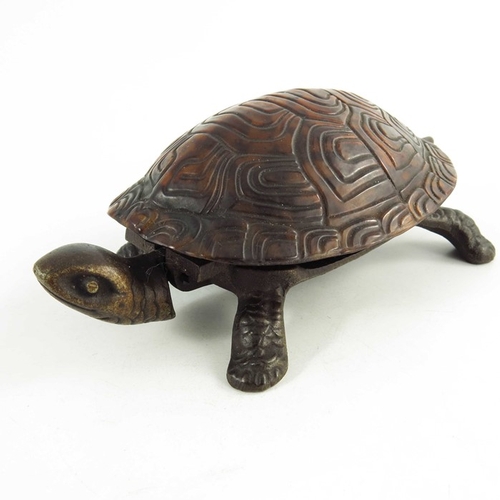 547 - A Victorian Cast iron mechanical table bell modelled as a tortoise, the tortoiseshell back mounted o... 