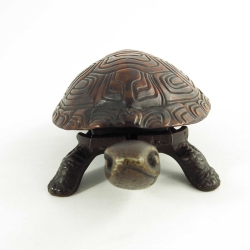 547 - A Victorian Cast iron mechanical table bell modelled as a tortoise, the tortoiseshell back mounted o... 