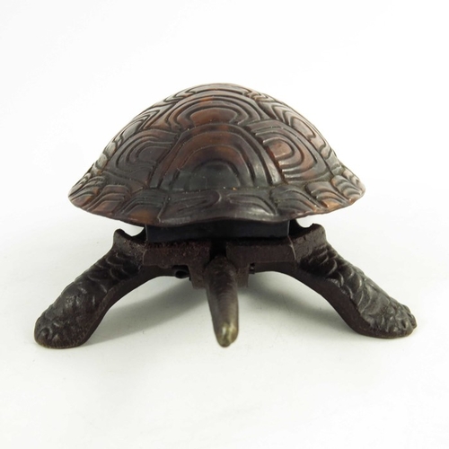 547 - A Victorian Cast iron mechanical table bell modelled as a tortoise, the tortoiseshell back mounted o... 