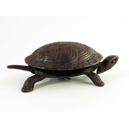 547 - A Victorian Cast iron mechanical table bell modelled as a tortoise, the tortoiseshell back mounted o... 