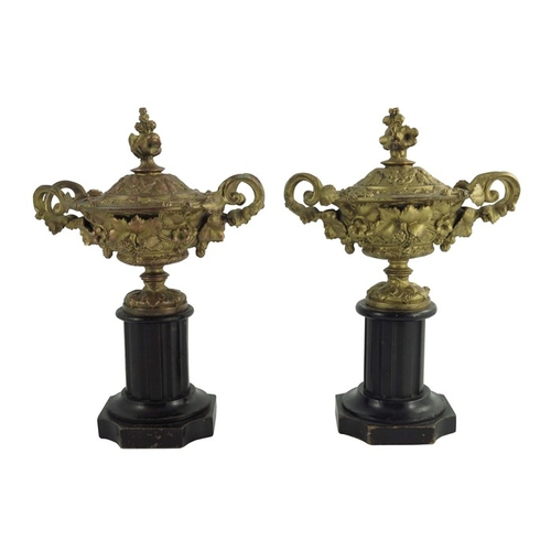 562 - A pair of gilt metal Warwick vases, with twin vine leaf cast handles, the body with entwined vines, ... 