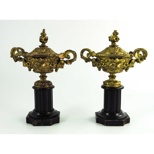 562 - A pair of gilt metal Warwick vases, with twin vine leaf cast handles, the body with entwined vines, ... 