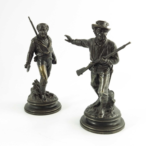 567 - Emile Guillemin, a pair of 19th century French bronze figures, dated 1871, modelled as pioneers, hol... 