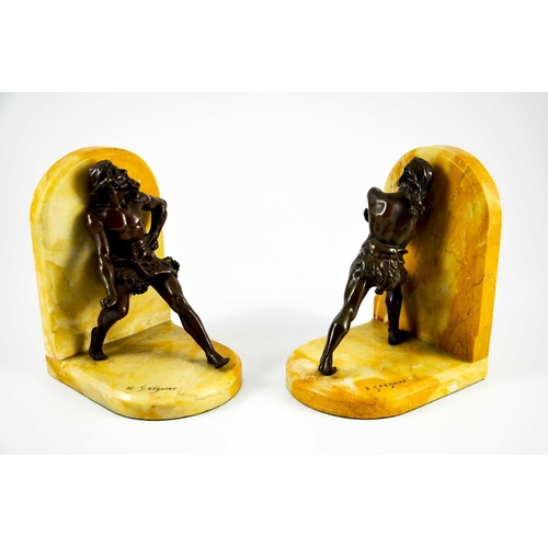 569 - Jean Louis Gregoire, a pair of bronze and Sienna marble bookends, modelled as cave men in animated s... 