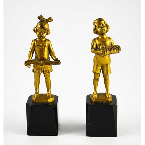 574 - J H Land, a pair of gilt bronze Art Deco figures, modelled as Dutch boy and girl with book and accor... 