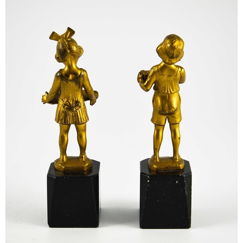 574 - J H Land, a pair of gilt bronze Art Deco figures, modelled as Dutch boy and girl with book and accor... 