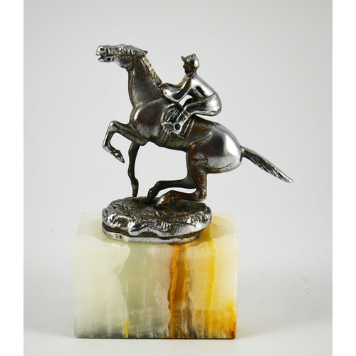 575 - Desmo, an Art Deco chrome plated jockey car mascot, modelled riding a horse, on onyx plinth, the rid... 