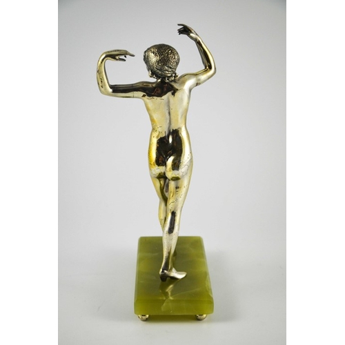 576 - An Art Deco silvered bronze figure of a nude flapper, circa 1925, in the style of Colinet, on green ... 