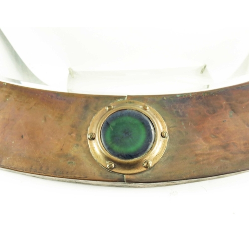 580 - Liberty and Co., an Arts and Crafts copper and Ruskin cabochon mirror, oval, planishe dand riveted w... 