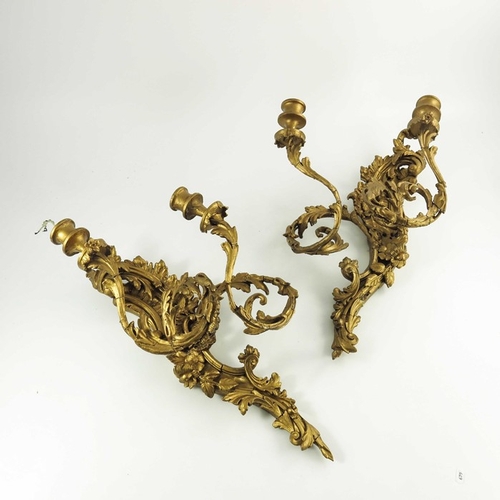 586 - A pair of 19th century double sconce gilded wall lights, scrolling foliate design, 53cm high (2)