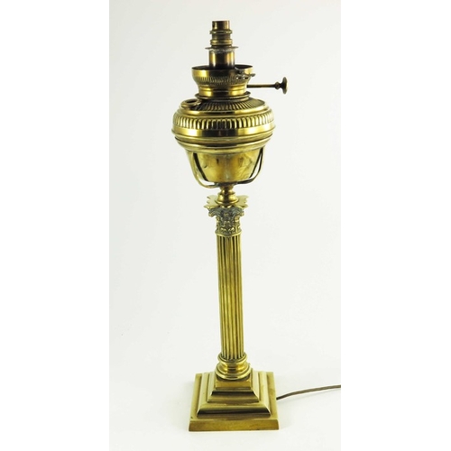 587 - A Victorian brass oil lamp, Corinthian column form with brass font on a square stepped base, marked ... 