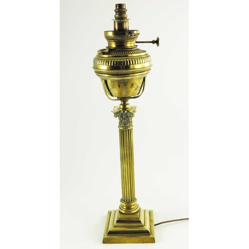 587 - A Victorian brass oil lamp, Corinthian column form with brass font on a square stepped base, marked ... 