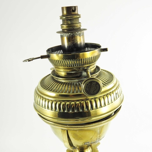 587 - A Victorian brass oil lamp, Corinthian column form with brass font on a square stepped base, marked ... 