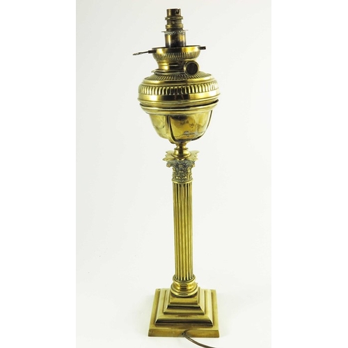 587 - A Victorian brass oil lamp, Corinthian column form with brass font on a square stepped base, marked ... 