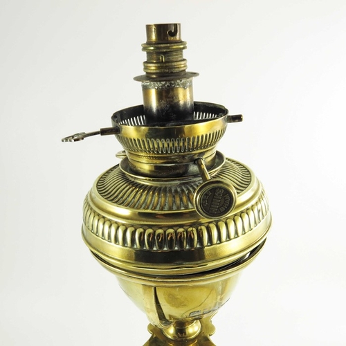 587 - A Victorian brass oil lamp, Corinthian column form with brass font on a square stepped base, marked ... 