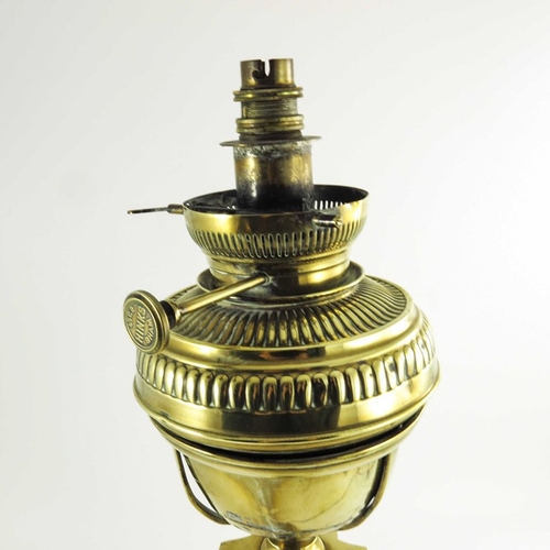 587 - A Victorian brass oil lamp, Corinthian column form with brass font on a square stepped base, marked ... 