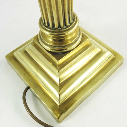 587 - A Victorian brass oil lamp, Corinthian column form with brass font on a square stepped base, marked ... 