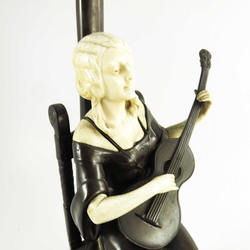 590 - A Continental Bronze and Ivory Figurative Lamp circa 1900, modelled as a seated lady playing a guita... 