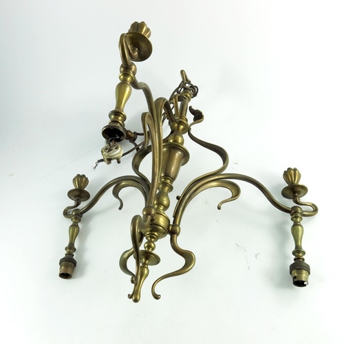 593 - An Arts and Crafts brass three light pendant chandelier, circa 1900, in the Art Nouveau style, sinuo... 