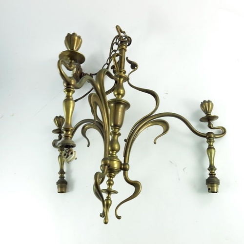 593 - An Arts and Crafts brass three light pendant chandelier, circa 1900, in the Art Nouveau style, sinuo... 