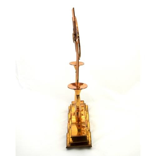 597 - A brass seafarers candelabra, by Francis Rosher, 1972, modelled as a ships wheel over waves, 51cm hi... 