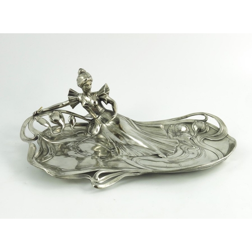 602 - WMF, a Jugendstil silver plated card tray, modelled in relief as a woman reading, reclining on an op... 