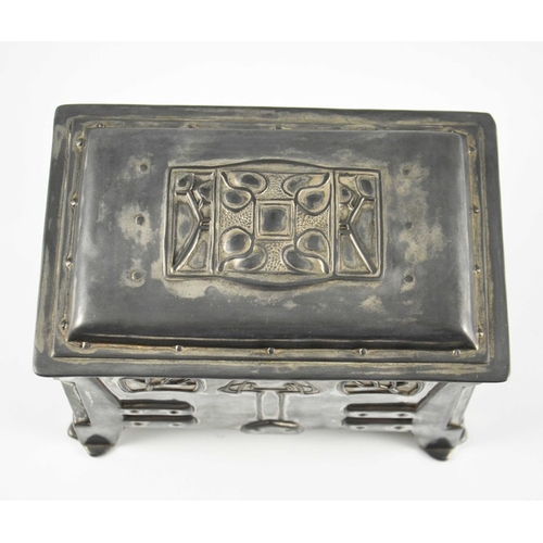 606 - A Secessionist pewter casket, cuboid form, embossed in relief with angular rivet work straps and cor... 