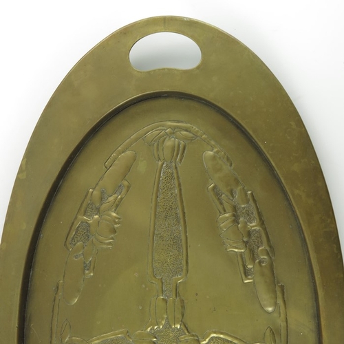 621 - Margaret Gilmour (attributed), a Glasgow School Arts and Crafts brass tray, oval form, repousse deco... 