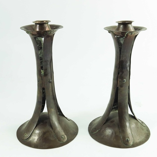 627 - A pair of Arts and Crafts copper candlesticks, in the style of Birmingham Guild of Handicraft, domed... 