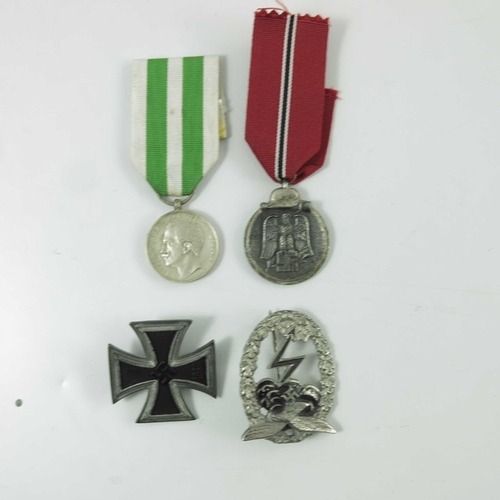 660 - A group of Second World War militaria related ephemera, including German medals, epaulettes and badg... 