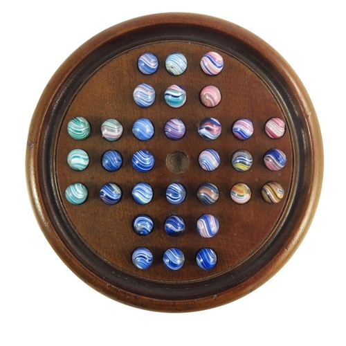 746 - A Victorian mahogany solitaire board with set of 32 pontilled onionskin marbles, board 19cm, marbles... 