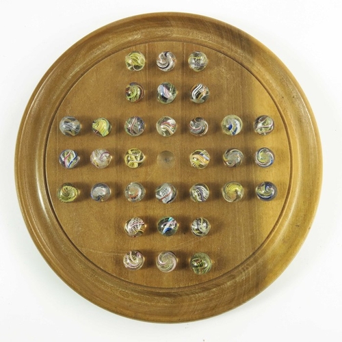 748 - A boxed solitaire by Glevum with wooden board and German pontilled swirl marbles, board 20.3cm, marb... 