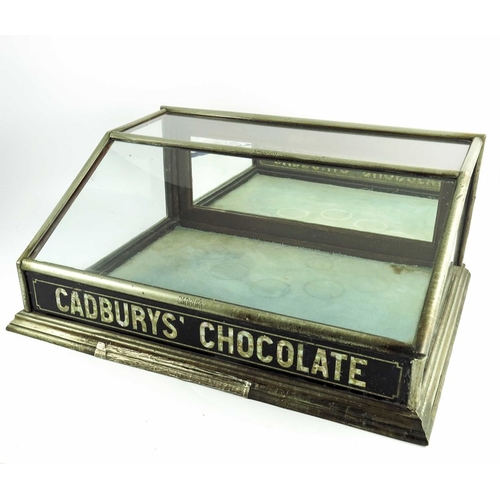 755 - A shop display cabinet for Cadbury's Chocolate, in a metal plated mahogany frame with sloping glass ... 