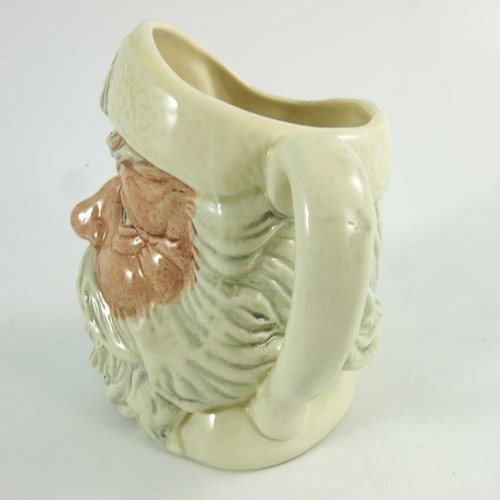 848 - A Royal Doulton small character jug, Santa Claus, with a white handle, 11cm high