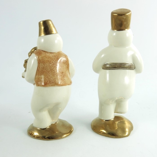 916 - Two Royal Doulton snowmen figures, Violinist and Drummer, gold and silver highlights colourway, prop... 