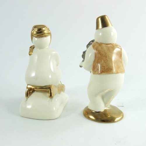 920 - Two Royal Doulton snowmen figures, Toboggan and Violinist, gold and silver highlights colourway, pro... 