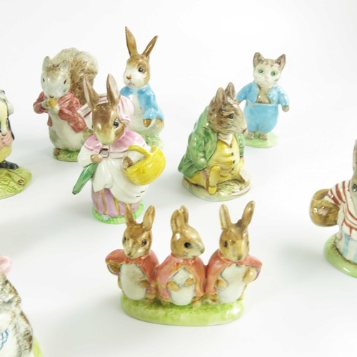 936 - A group of fourteen Beswick Beatrix Potter figures, gold backstamps, printed marks (14)