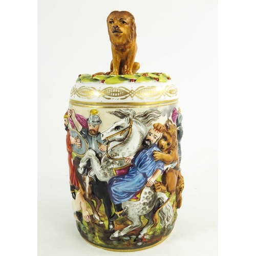 961 - An Italian Naples Capodimonte type relief moulded lidded tankard, together with a figure of a travel... 