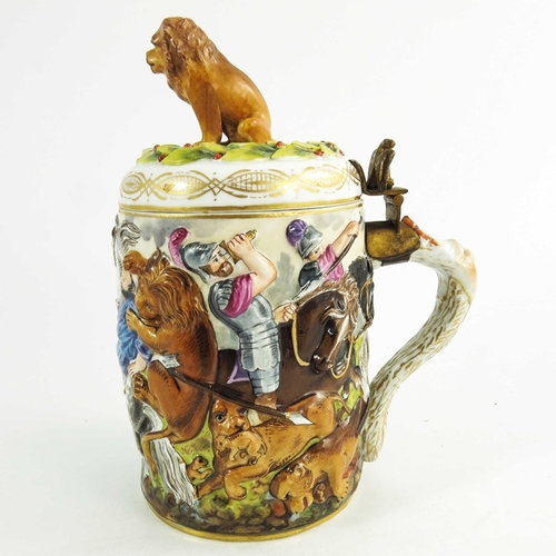 961 - An Italian Naples Capodimonte type relief moulded lidded tankard, together with a figure of a travel... 