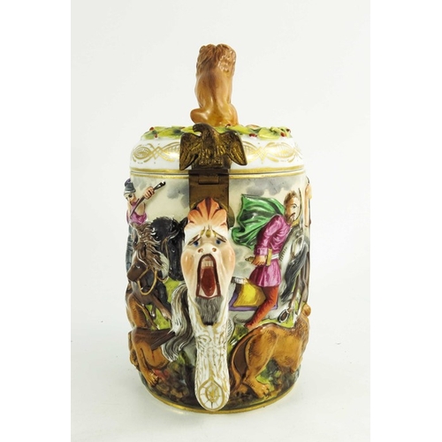 961 - An Italian Naples Capodimonte type relief moulded lidded tankard, together with a figure of a travel... 