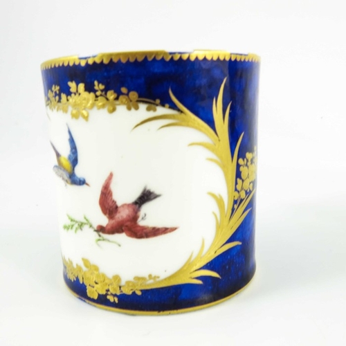 963 - A Sevres porcelain coffee can and saucer, circa 1800, painted with exotic  birds within gilt feather... 