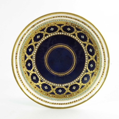 965 - A Sevres porcelain coffee can and saucer, circa 1800, later decorated with tooled gilt and jewelled ... 